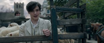 Movie still from “Enola Holmes” (2020), directed by Harry Bradbeer – A young man leaning on a wooden fence; Close Up shot, Over the shoulder angle