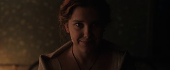 Movie still from “Enola Holmes” (2020), directed by Harry Bradbeer – A woman's face in the dark; Close Up shot, Low angle