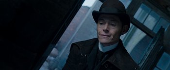 Movie still from “Enola Holmes” (2020), directed by Harry Bradbeer – A person wearing a hat and a coat; Close Up shot, Low angle