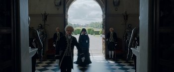 Movie still from “Enola Holmes” (2020), directed by Harry Bradbeer – A group of people dressed in period costumes; Wide shot, Low angle