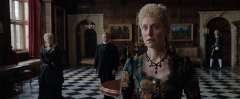 Movie still from “Enola Holmes” (2020), directed by Harry Bradbeer – A woman standing in front of a man in a room; Medium shot, Over the shoulder angle