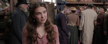 Movie still from “Enola Holmes” (2020), directed by Harry Bradbeer – A young woman in a pink shirt and brown hat; Close Up shot, Over the shoulder angle