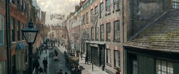 Movie still from “Enola Holmes” (2020), directed by Harry Bradbeer – An image of an old fashioned street scene in the 1 8 0 0's; Extreme Wide shot, High angle