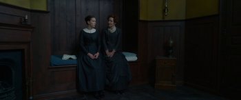 Movie still from “Enola Holmes” (2020), directed by Harry Bradbeer – Two women sitting next to each other on a bench; Medium shot, High angle