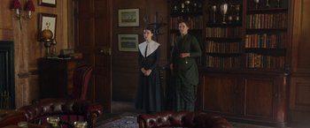 Movie still from “Enola Holmes” (2020), directed by Harry Bradbeer – Two women dressed in period clothing standing in a room; Wide shot, Low angle
