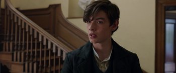 Movie still from “Enola Holmes” (2020), directed by Harry Bradbeer – A young man in a suit and tie; Close Up shot, Over the shoulder angle