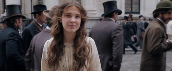 Movie still from “Enola Holmes” (2020), directed by Harry Bradbeer – A woman with long brown hair wearing a top hat; Close Up shot, Over the shoulder angle