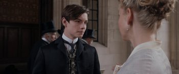 Movie still from “Enola Holmes” (2020), directed by Harry Bradbeer – A young man in a suit and tie talking to a woman; Close Up shot, Over the shoulder angle