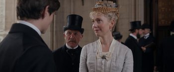 Movie still from “Enola Holmes” (2020), directed by Harry Bradbeer – A man and a woman in a top hat; Medium shot, Over the shoulder angle