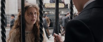 Movie still from “Enola Holmes” (2020), directed by Harry Bradbeer – A woman is looking at a man on a city street; Close Up shot, Over the shoulder angle