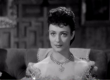 Movie still from “Kind Hearts and Coronets” (1949), directed by Robert Hamer – An old photo of a woman wearing a necklace; Close Up shot, High angle