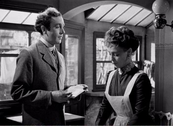 Movie still from “Kind Hearts and Coronets” (1949), directed by Robert Hamer – A man and a woman are looking at each other; Medium shot, Low angle