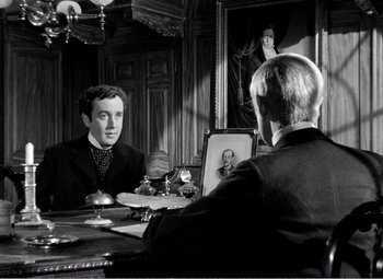 Movie still from “Kind Hearts and Coronets” (1949), directed by Robert Hamer – Two men sitting at a table in front of a mirror; Medium shot, Over the shoulder angle