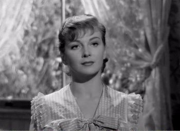 Movie still from “Kind Hearts and Coronets” (1949), directed by Robert Hamer – A black - and - white photo of a woman in a dress; Close Up shot, Over the shoulder angle