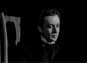Movie still from “Kind Hearts and Coronets” (1949), directed by Robert Hamer – A black and white photo of a man in a suit; Close Up shot, Low angle