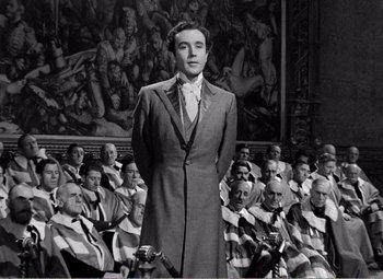 Movie still from “Kind Hearts and Coronets” (1949), directed by Robert Hamer – A black and white photo of a man in a suit; Medium shot, High angle