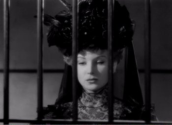 Movie still from “Kind Hearts and Coronets” (1949), directed by Robert Hamer – A black and white photo of a woman wearing a hat; Close Up shot, Low angle