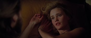 Movie still from “King Kong” (1976), directed by John Guillermin – A woman laying on the ground with her hand on her head; Close Up shot, Overhead angle