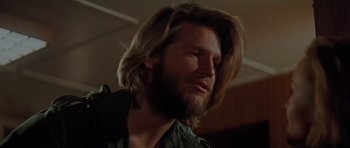 Movie still from “King Kong” (1976), directed by John Guillermin – A person with long hair and a beard; Close Up shot, Low angle