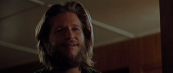 Movie still from “King Kong” (1976), directed by John Guillermin – A person with long hair and a beard; Close Up shot, Low angle