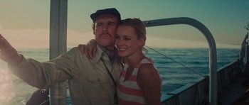 Movie still from “King Kong” (1976), directed by John Guillermin – A man and a woman posing for a picture on a sailboat; Close Up shot, Low angle