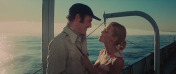 Movie still from “King Kong” (1976), directed by John Guillermin – A man and a woman standing next to each other on a boat in the ocean; Medium shot, Low angle