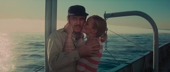 Movie still from “King Kong” (1976), directed by John Guillermin – A man and a woman kissing on a boat in the ocean; Close Up shot, Low angle