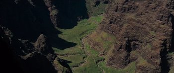 Movie still from “King Kong” (1976), directed by John Guillermin – A view of a valley from a helicopter; Extreme Wide shot, High angle