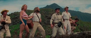 Movie still from “King Kong” (1976), directed by John Guillermin – A group of people standing on top of a hill; Medium shot, Low angle