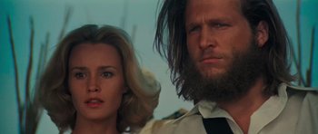 Movie still from “King Kong” (1976), directed by John Guillermin – A man and a woman standing next to each other; Close Up shot, Low angle