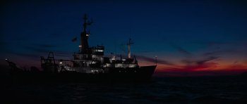 Movie still from “King Kong” (1976), directed by John Guillermin – A large boat in the water at night; Extreme Wide shot, Low angle