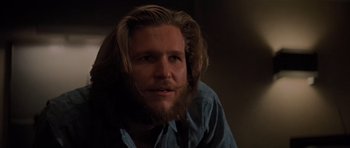 Movie still from “King Kong” (1976), directed by John Guillermin – A man with long hair and a long beard; Close Up shot, Low angle