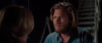 Movie still from “King Kong” (1976), directed by John Guillermin – A person with long hair; Close Up shot, Over the shoulder angle