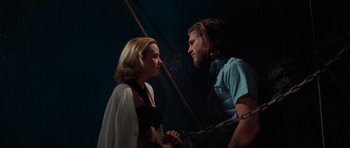 Movie still from “King Kong” (1976), directed by John Guillermin – A man and a woman standing next to each other on a boat; Medium shot, Low angle