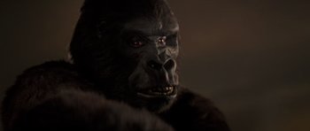 Movie still from “King Kong” (1976), directed by John Guillermin – A gorilla's face in a dimly - lit room; Close Up shot, Low angle