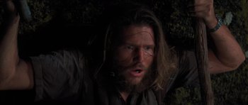 Movie still from “King Kong” (1976), directed by John Guillermin – A man with long hair and a long beard; Close Up shot, High angle