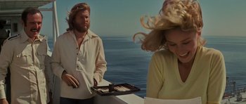 Movie still from “King Kong” (1976), directed by John Guillermin – A man and a woman standing on a boat in front of the ocean; Medium shot, Over the shoulder angle