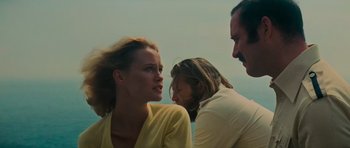 Movie still from “King Kong” (1976), directed by John Guillermin – A woman and two men talking to each other; Medium shot, Low angle