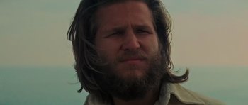 Movie still from “King Kong” (1976), directed by John Guillermin – A person with long hair and a beard; Close Up shot, Low angle