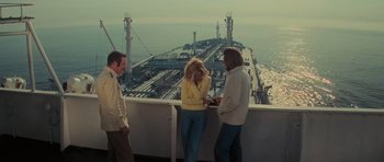 Movie still from “King Kong” (1976), directed by John Guillermin – A group of people standing next to each other on top of a boat; Wide shot, High angle