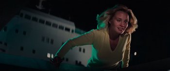 Movie still from “King Kong” (1976), directed by John Guillermin – A woman riding a bike on top of a ramp; Medium shot, Low angle