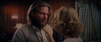 Movie still from “King Kong” (1976), directed by John Guillermin – A man with long hair and a long beard; Close Up shot, Over the shoulder angle