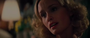 Movie still from “King Kong” (1976), directed by John Guillermin – A woman's face in a dark room; Close Up shot, Over the shoulder angle