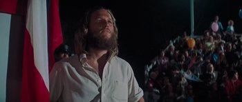 Movie still from “King Kong” (1976), directed by John Guillermin – A man with long hair and a long beard is looking up; Close Up shot, Low angle