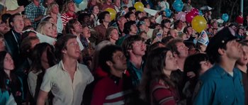 Movie still from “King Kong” (1976), directed by John Guillermin – A group of people in a stadium watching a game; Medium shot, High angle
