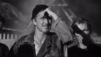 Movie still from “King Rat” (1965), directed by Bryan Forbes – A black and white photo of a man crying; Close Up shot, Low angle