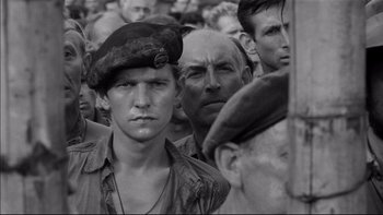 Movie still from “King Rat” (1965), directed by Bryan Forbes – Black and white photograph of a group of men; Close Up shot, High angle