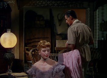 Movie still from “King Solomon's Mines” (1950), directed by Andrew Marton – A man and a woman in a room with a chair; Medium shot, Over the shoulder angle