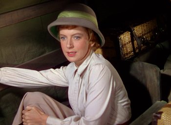 Movie still from “King Solomon's Mines” (1950), directed by Andrew Marton – A woman sitting on the ground wearing a hat; Close Up shot, Low angle