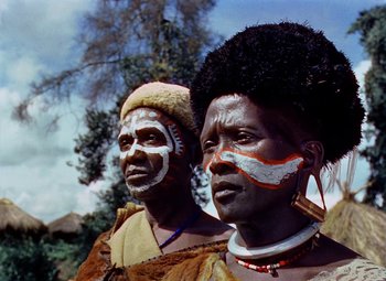 Movie still from “King Solomon's Mines” (1950), directed by Andrew Marton – A couple of people standing next to each other on top of a field; Close Up shot, Low angle